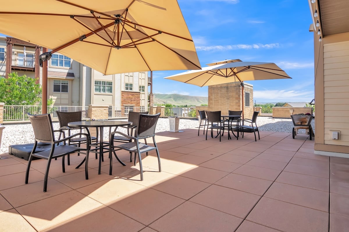 outdoor patio with tables covered by umbrellas
