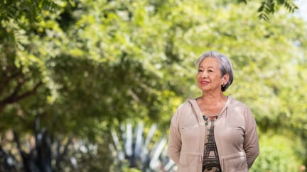 Senior walking in the garden while smiling