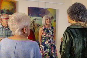 Group of people enjoying an art show