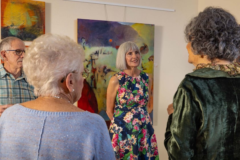 Group of people enjoying an art show