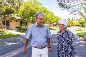 Asian man and woman standing in roadway
