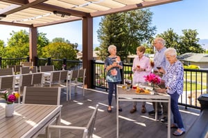 Four people standing on dining deck