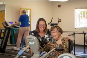 Woman on recumbent bike with trainer