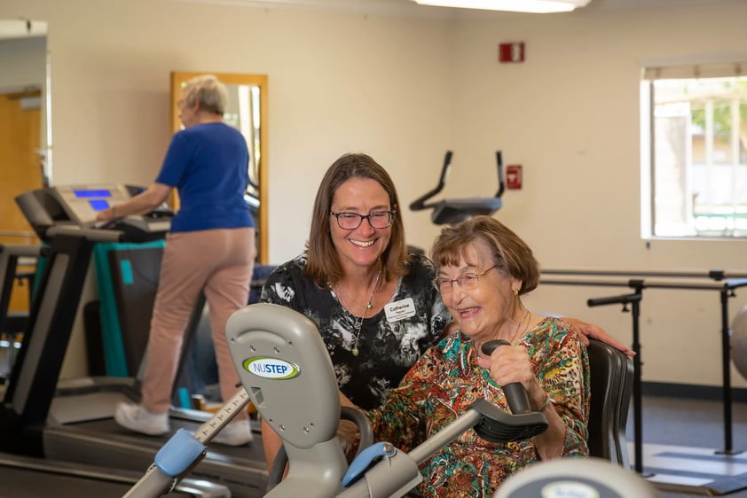 Woman on recumbent bike with trainer