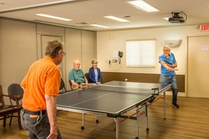 Two man playing ping pong