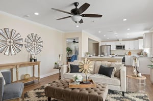 Living room w/white kitchen in back