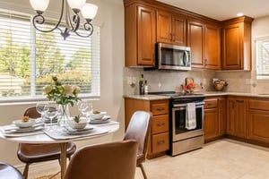 Brown kitchen with small dining set with leather chairs