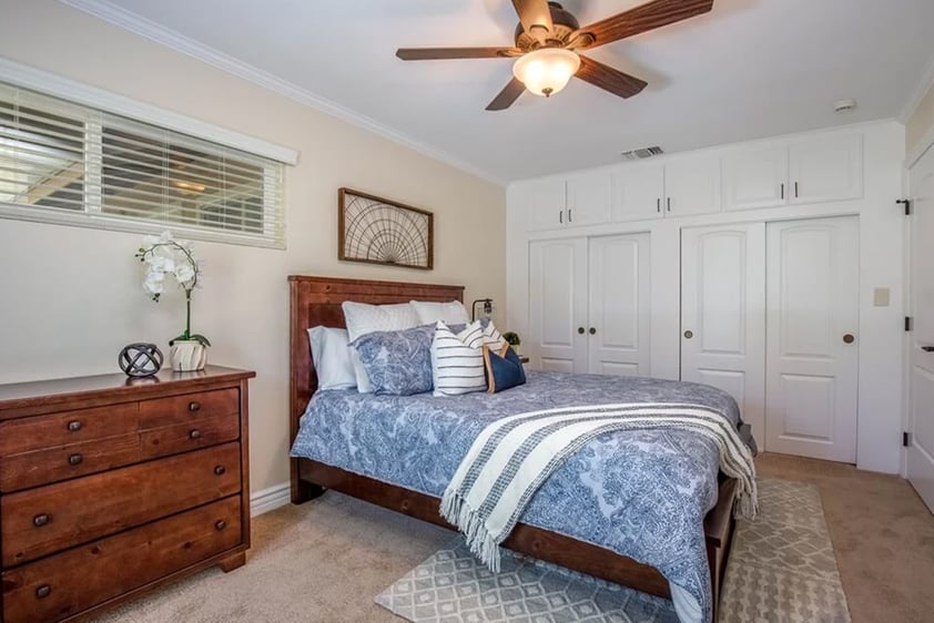 Bedroom with light blue and white bedspread