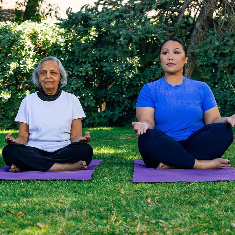 two women doing yoga