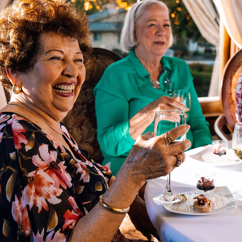 two women with glass of wine