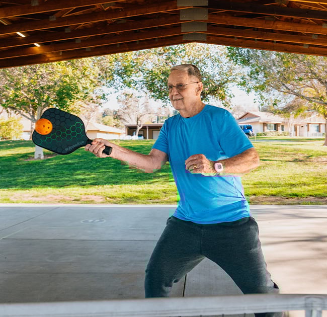 senior playing pickleball 