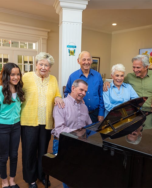 family gathered around a grand piano