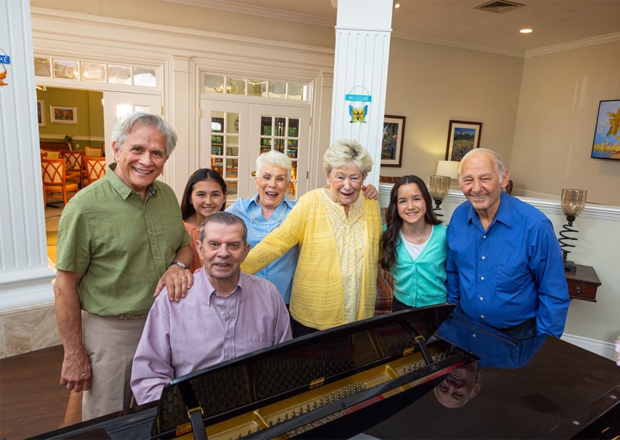 family gathered around a piano