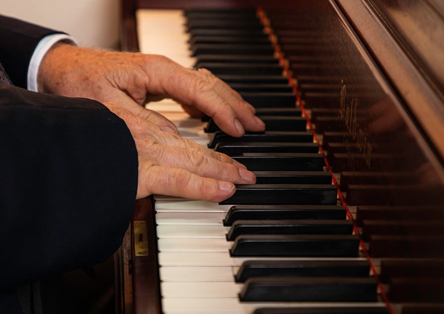 close up of a senior playing the piano