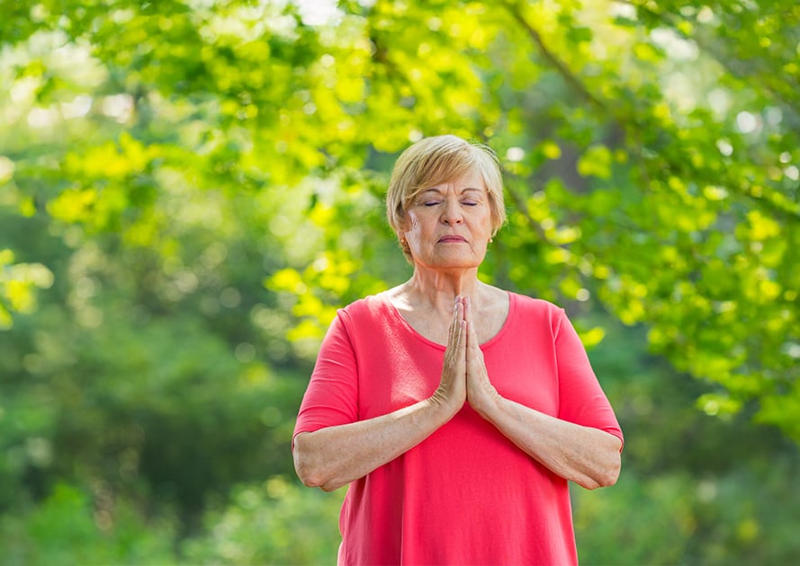 senior outside doing yoga