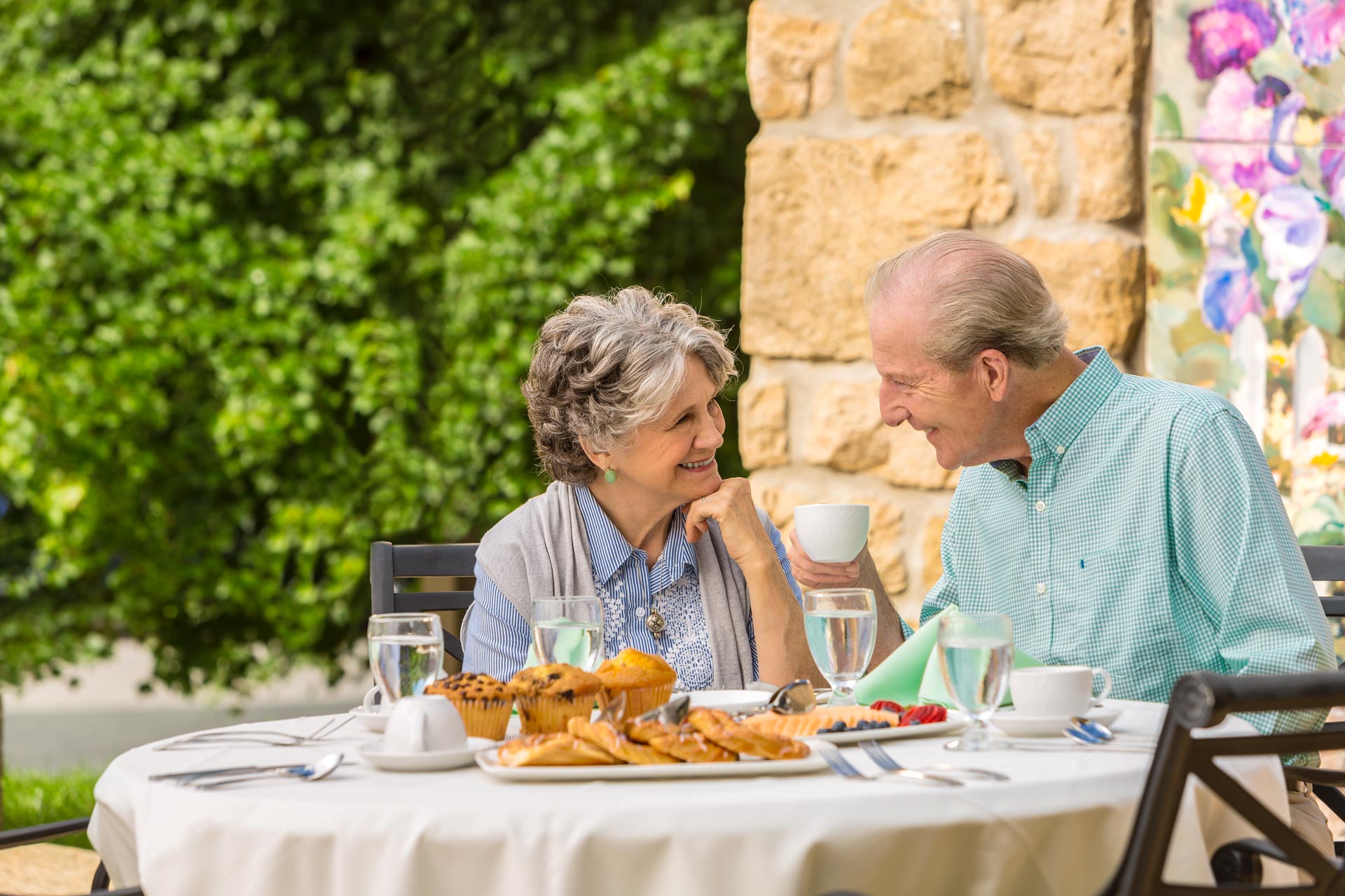 senior couple enjoying breakfast on patio