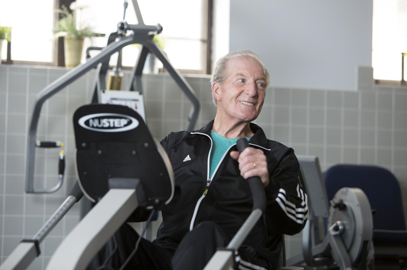 senior at the gym on an exercise machine