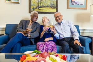 senior friends enjoying white wine together