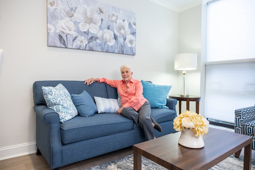 resident sitting on couch inside apartment