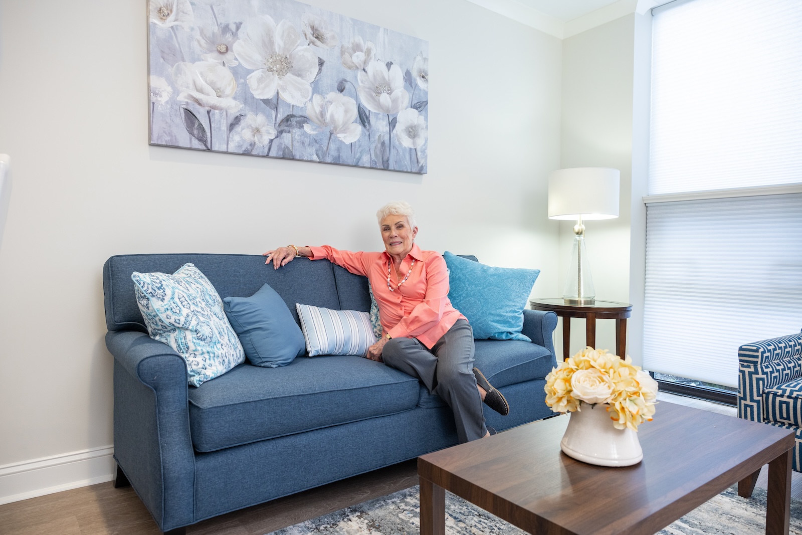 resident sitting on couch inside apartment