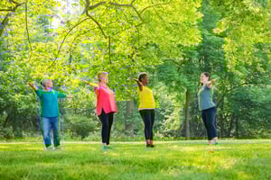 group of seniors outside doing tai chi