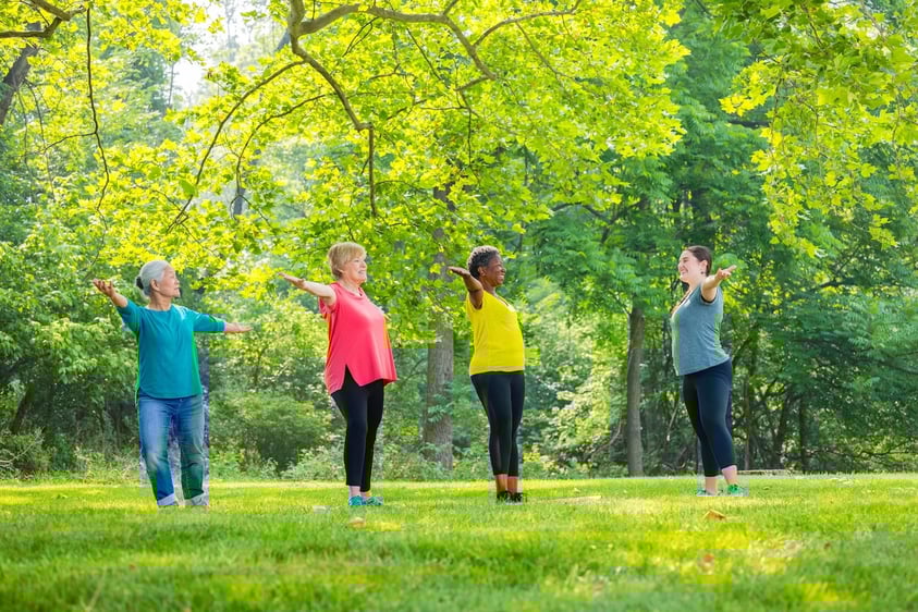 group of seniors outside doing tai chi